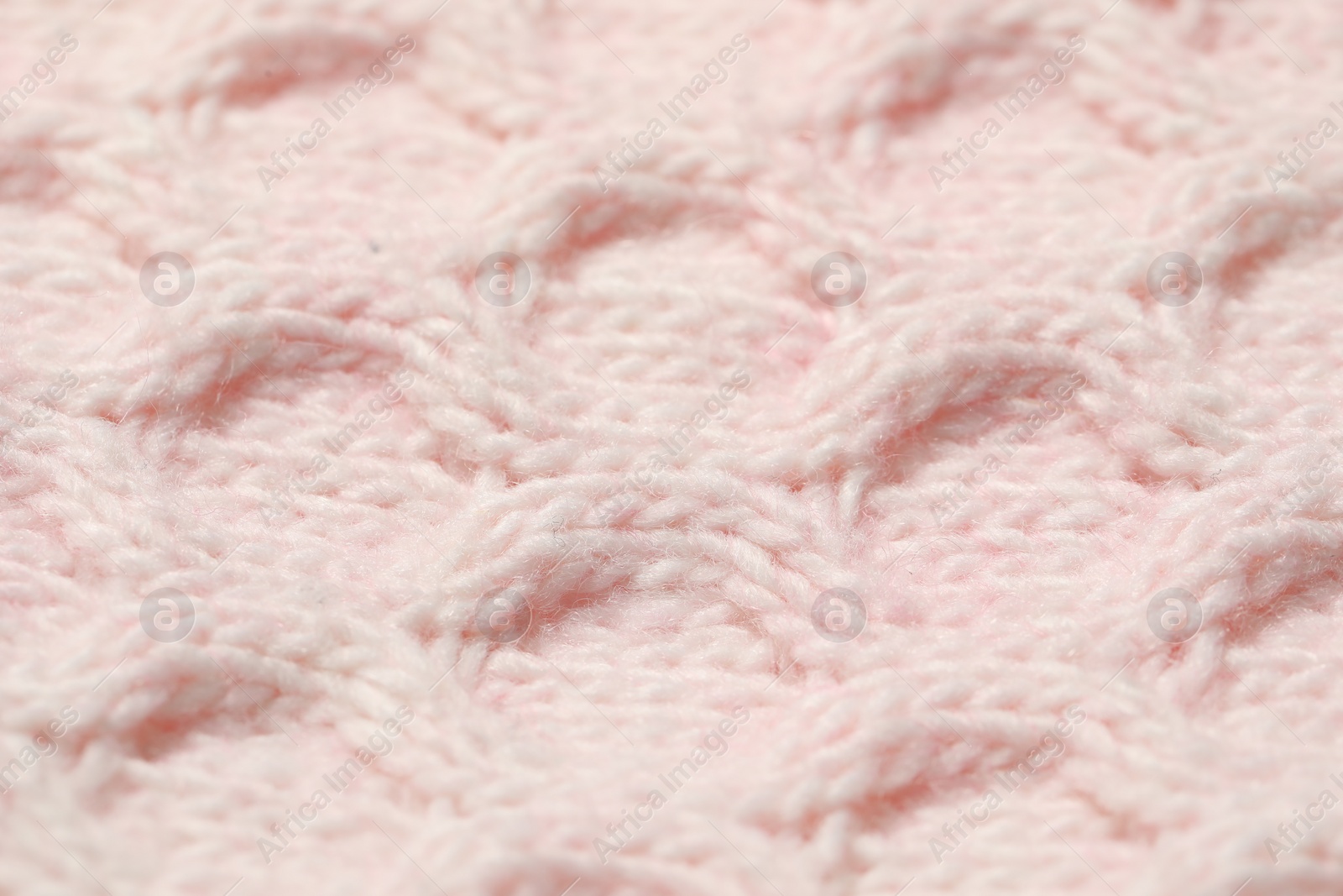 Photo of Texture of soft pink knitted fabric as background, closeup