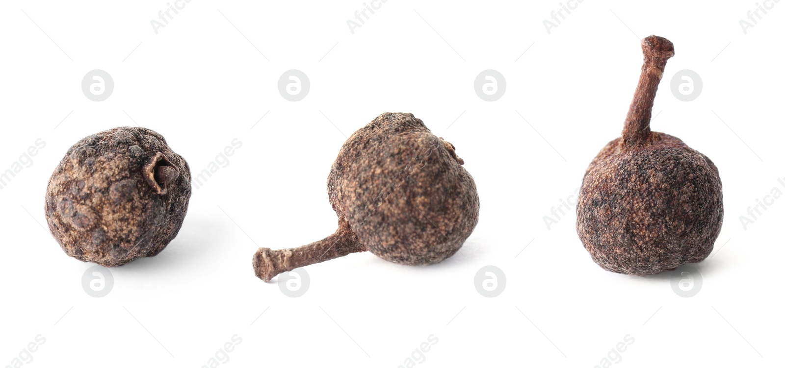 Image of Three allspice peppercorns on white background, closeup