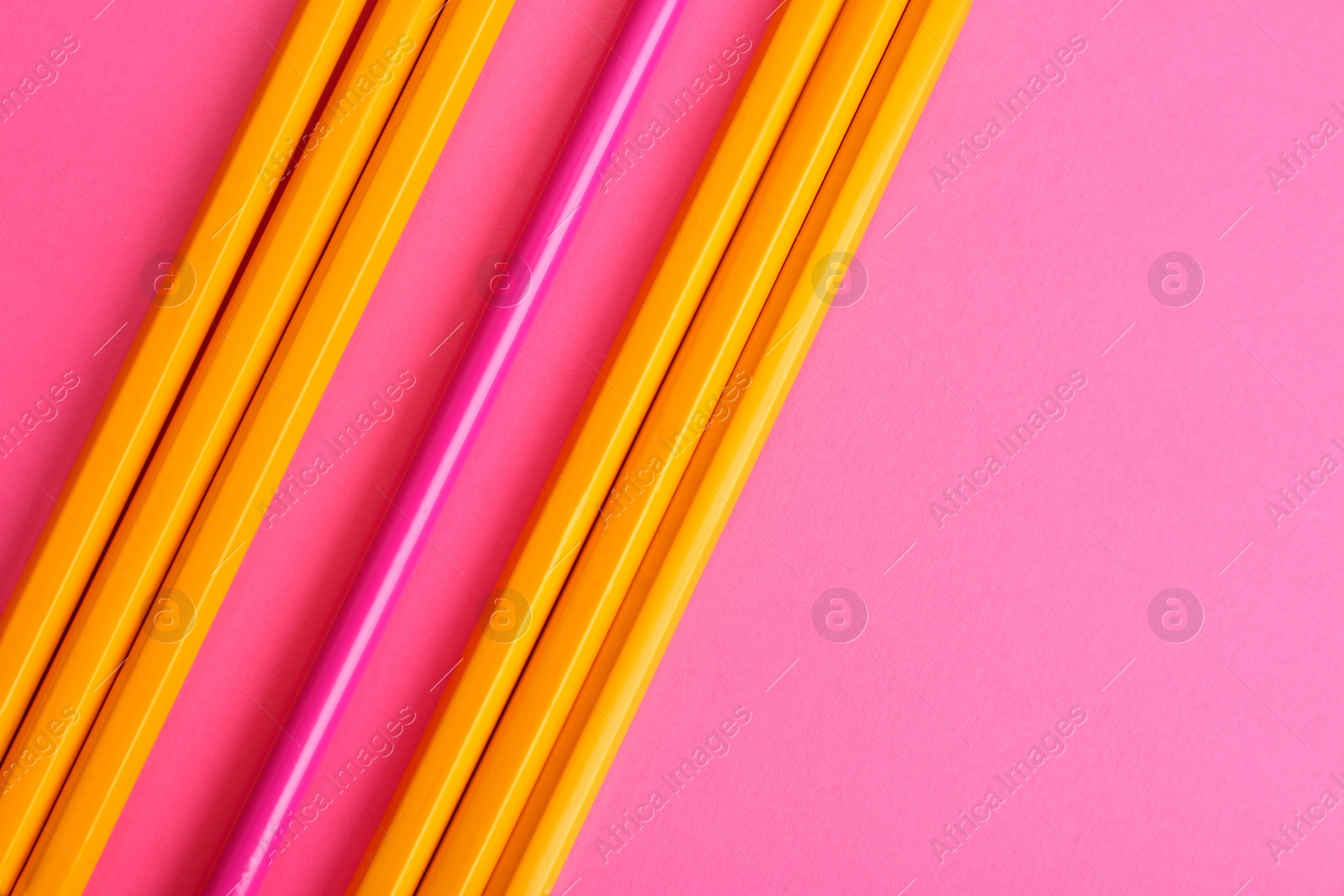 Photo of Flat lay composition with colorful pencils on pink background. Space for text