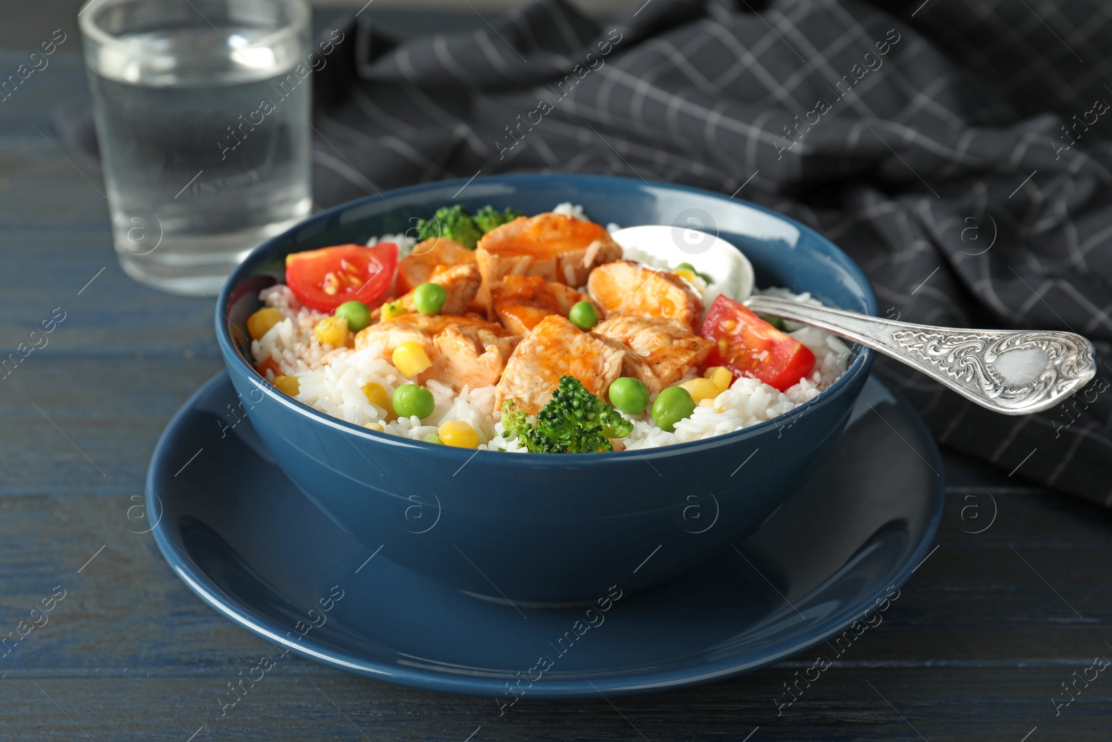 Photo of Bowl of boiled rice with vegetables and meat on table