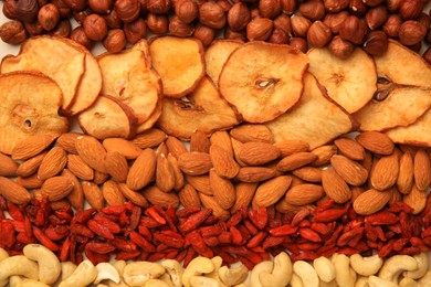 Mix of delicious dried nuts and fruits as background, top view