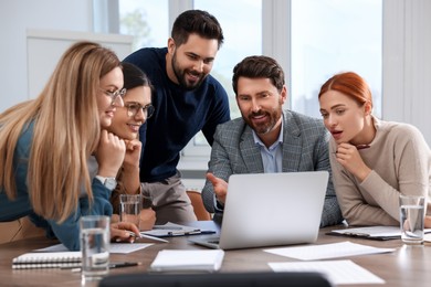 Team of employees working together in office