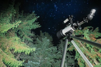 Photo of Modern telescope at night outdoors, low angle view. Learning astronomy