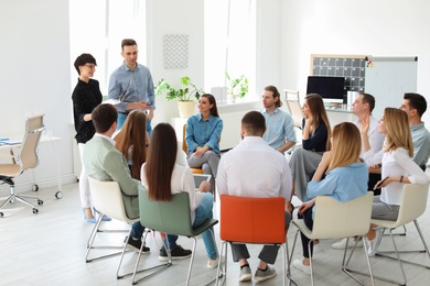 Photo of Young people having business training in office