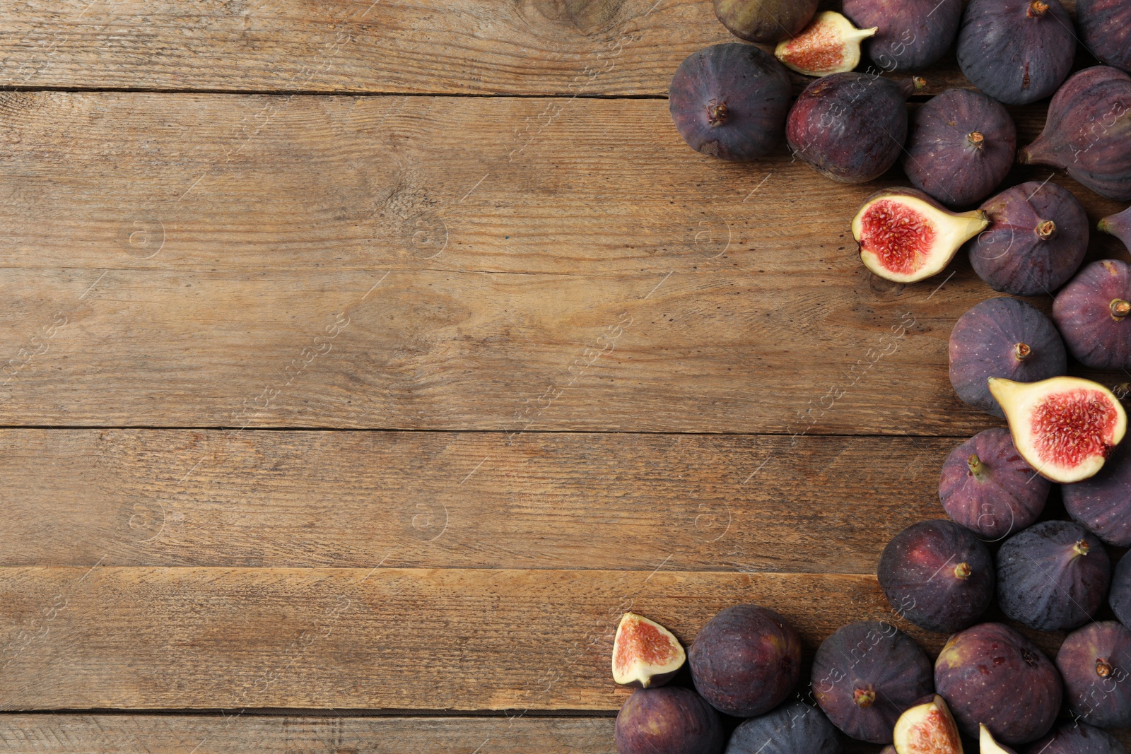 Photo of Tasty fresh figs on wooden table , flat lay. Space for text