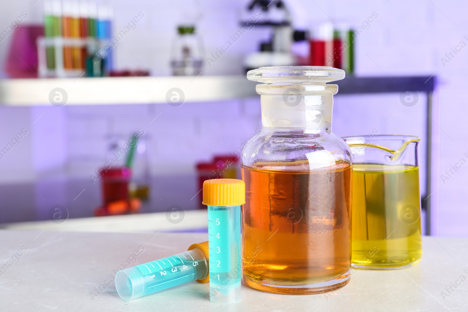 Photo of Different glassware with samples on table in chemistry laboratory. Space for text