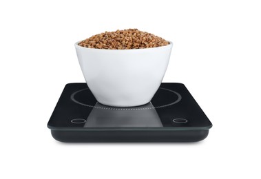 Photo of Modern kitchen scale with bowl of raw buckwheat isolated on white