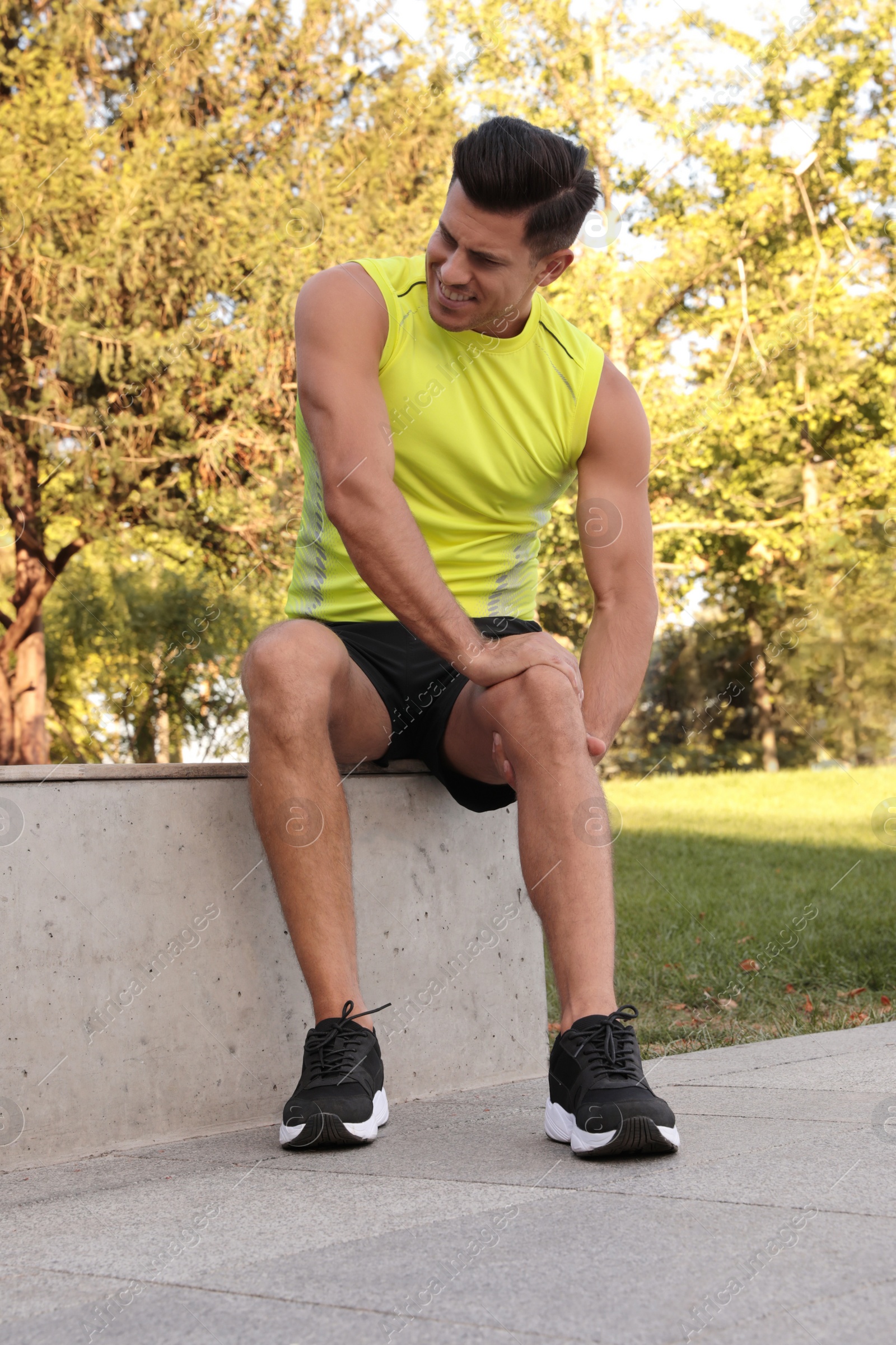 Photo of Man in sportswear having knee problems in park