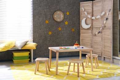 Baby room interior with wooden furniture and toys