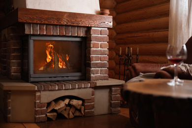 Photo of Modern cottage interior with stylish furniture and fireplace. Winter vacation