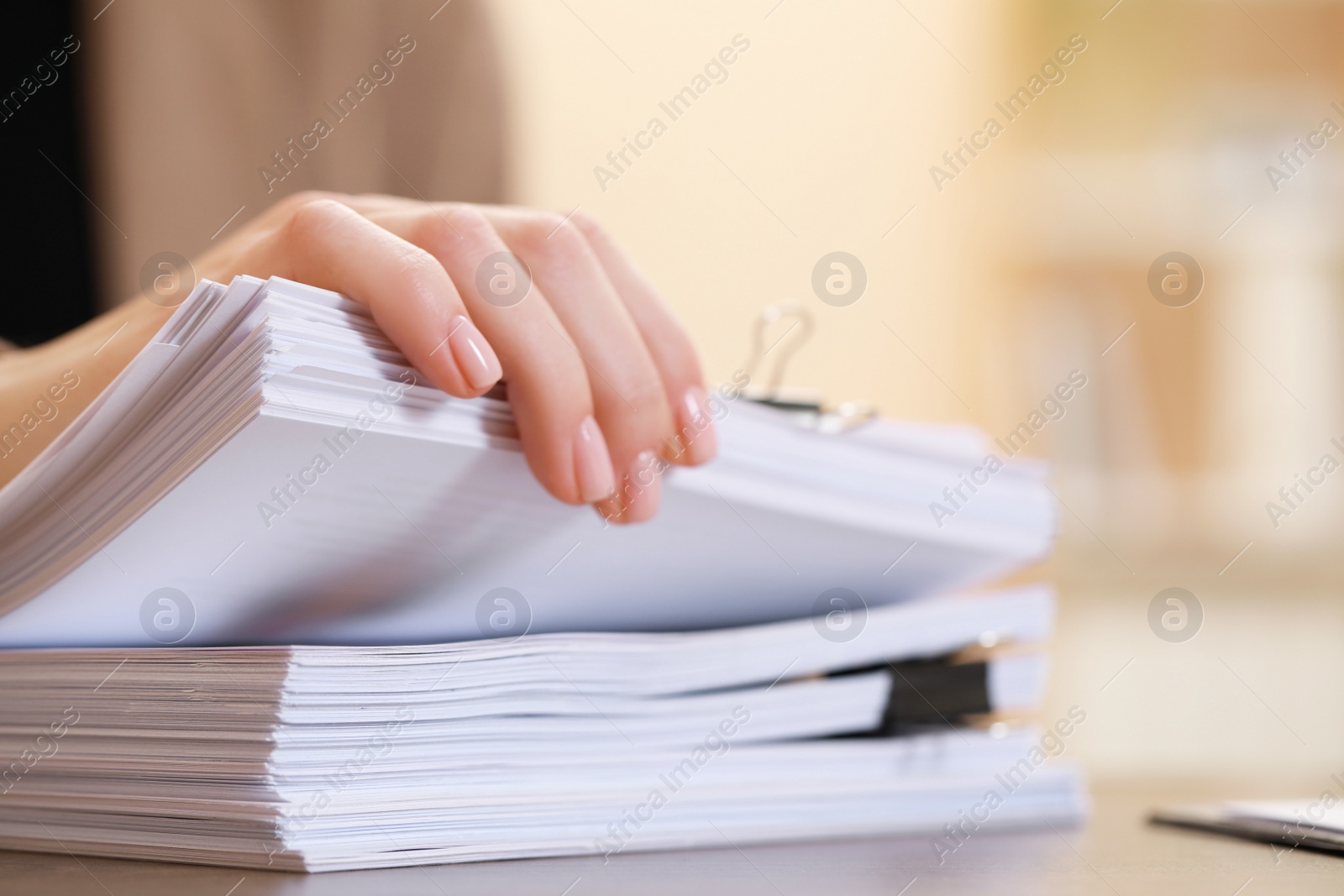 Photo of Woman working with documents at table in office, closeup