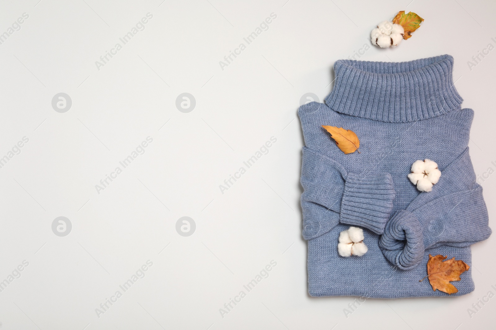 Photo of Warm sweater, dry leaves and cotton flowers on white background, top view with space for text. Autumn season