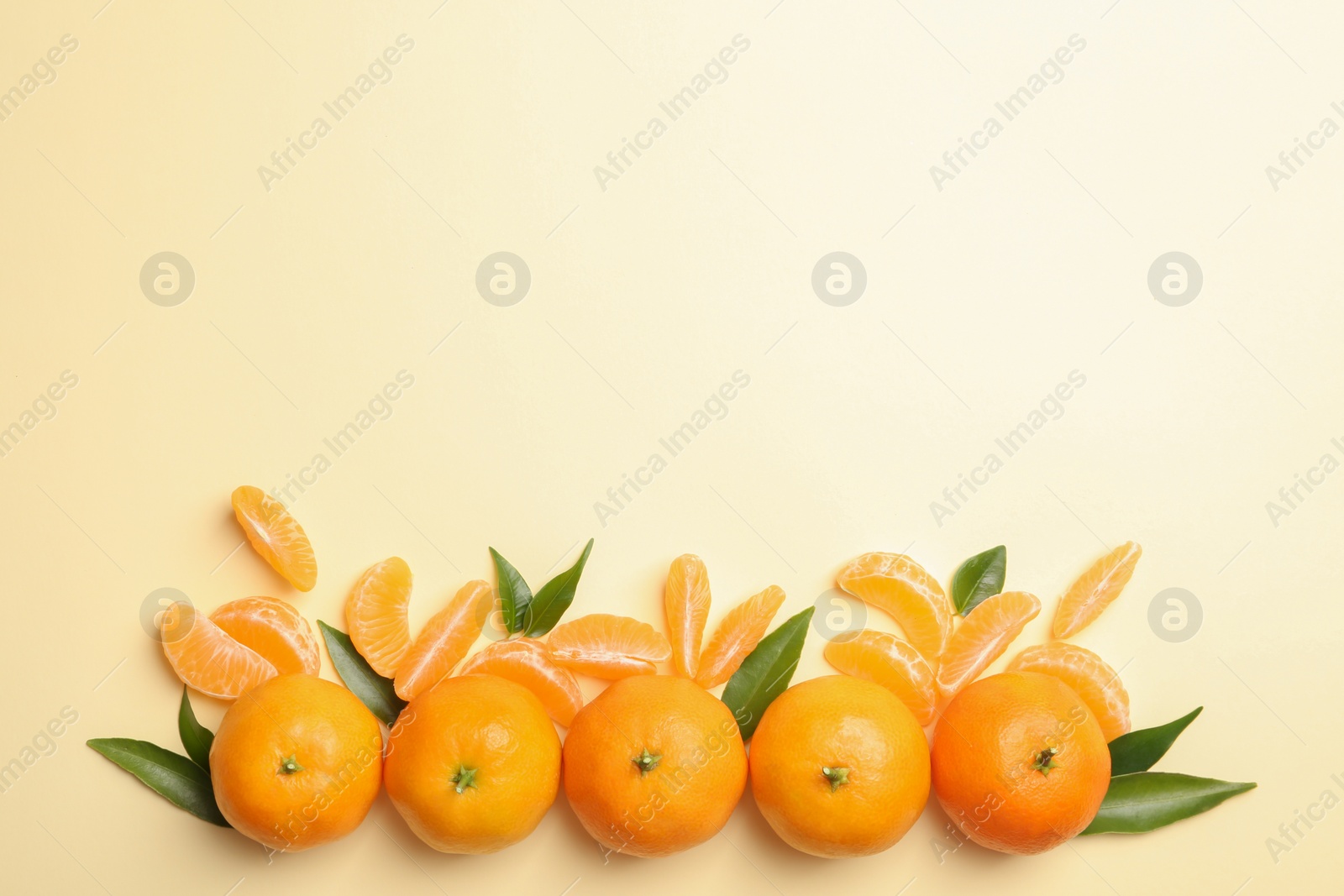 Photo of Composition with tangerines and leaves on color background, flat lay. Space for text