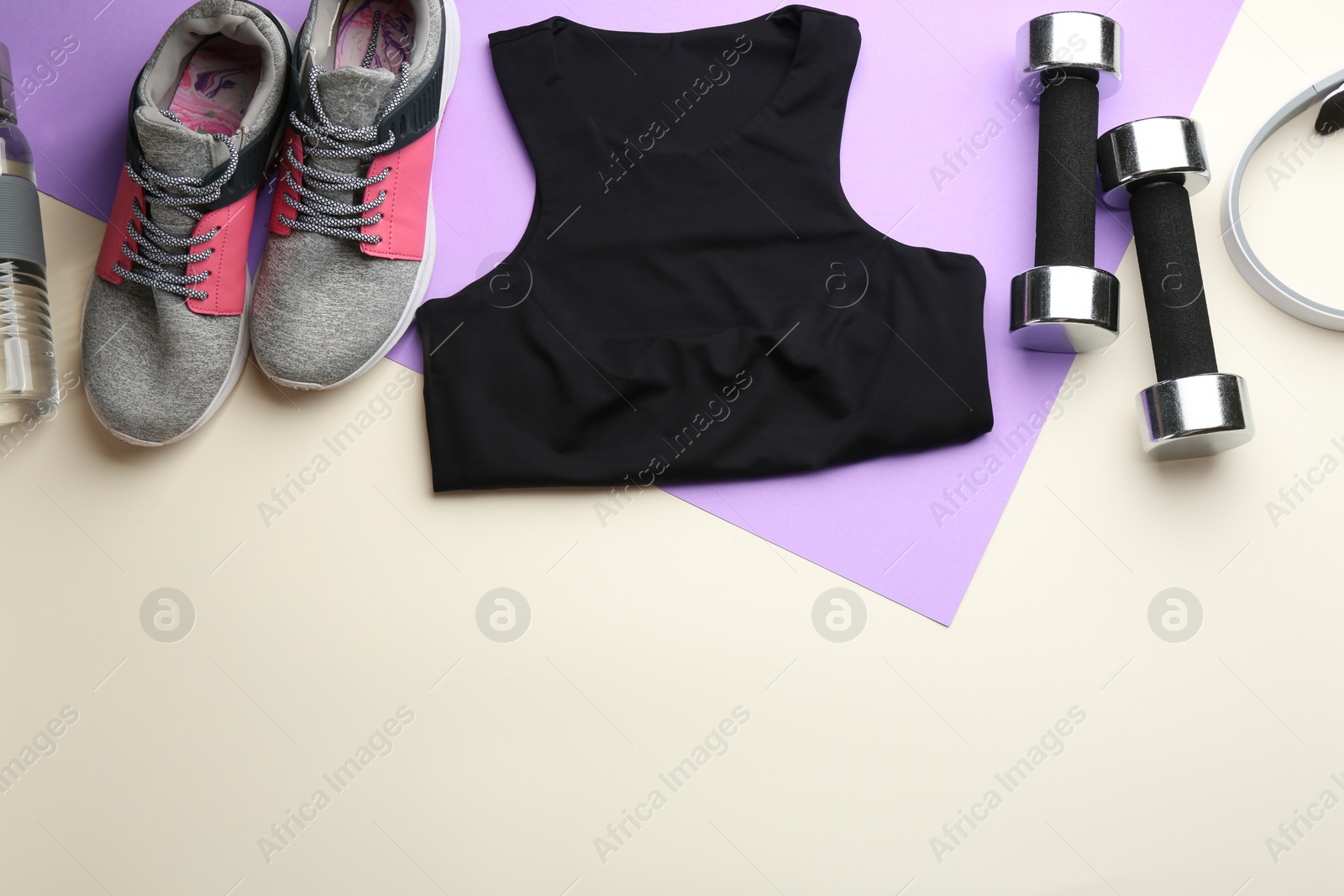 Photo of Flat lay composition with sportswear and equipment on color background, space for text. Gym workout