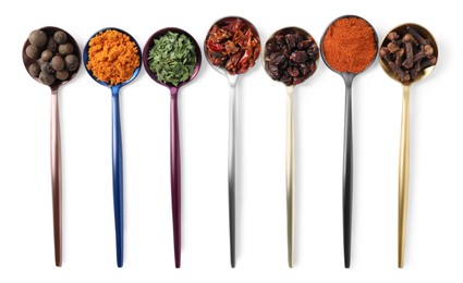 Metal spoons with different spices on white background, top view