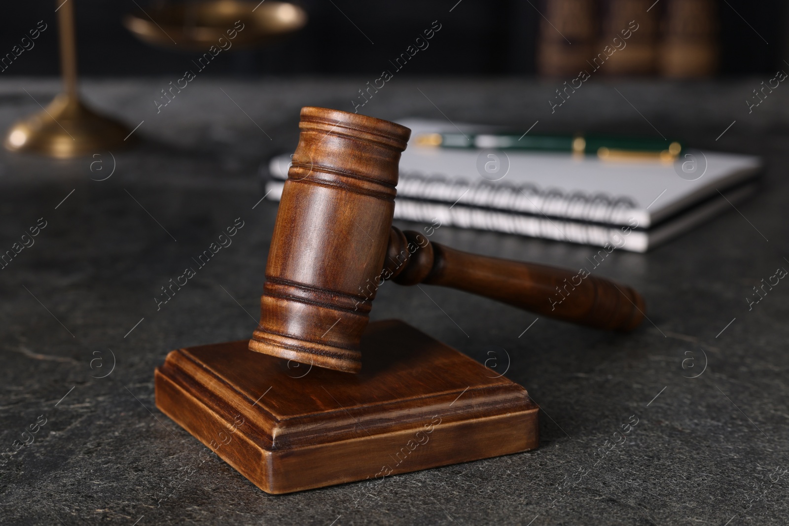 Photo of Law concept. Judge's gavel on grey textured table, closeup