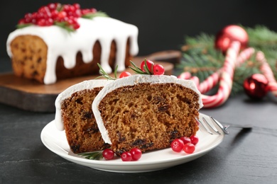 Photo of Traditional Christmas cake on black table, closeup. Classic recipe
