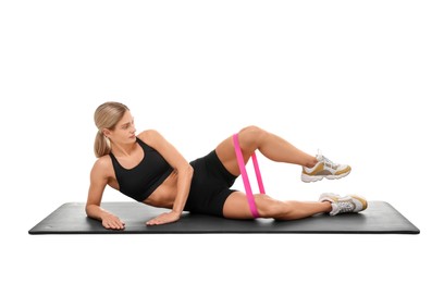 Photo of Woman exercising with elastic resistance band on fitness mat against white background