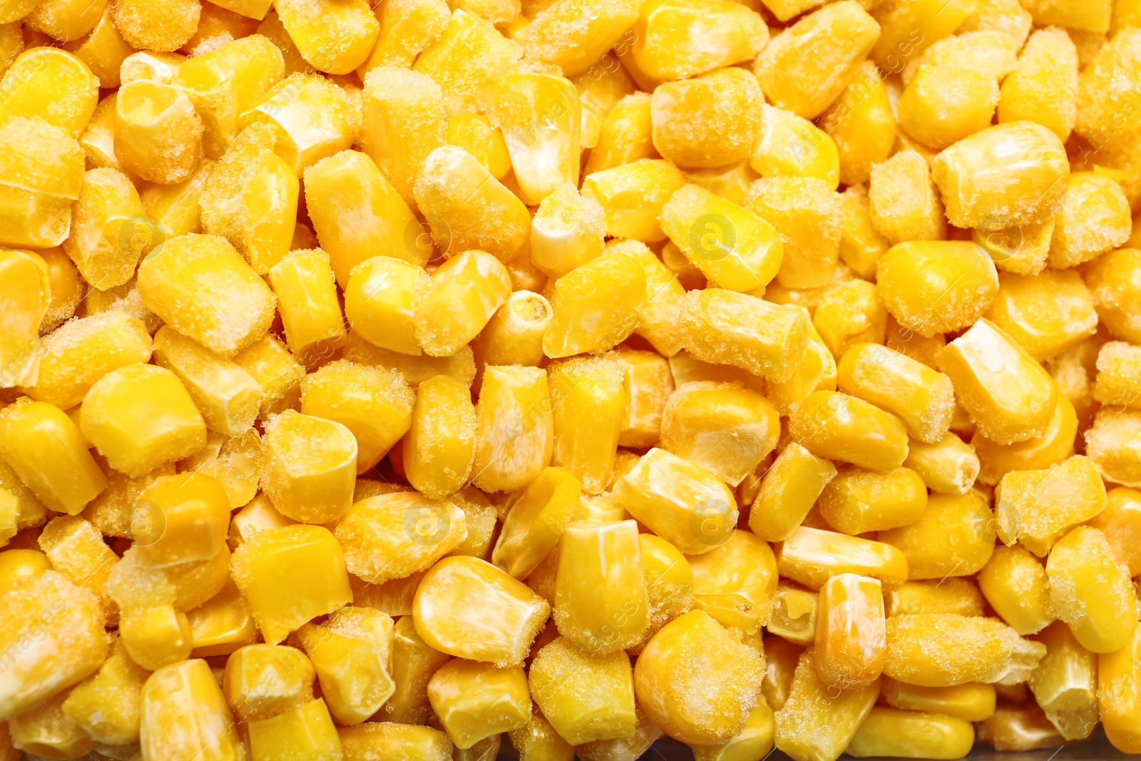 Photo of Pile of frozen corn kernels as background, closeup