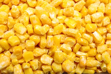 Pile of frozen corn kernels as background, closeup