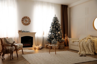 Photo of Beautiful living room interior with decorated Christmas tree and modern fireplace