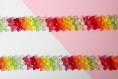 Delicious little jelly bears on color background, top view. Space for text