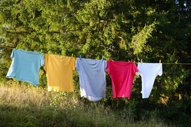 Photo of Washing line with clothes outdoors on sunny day