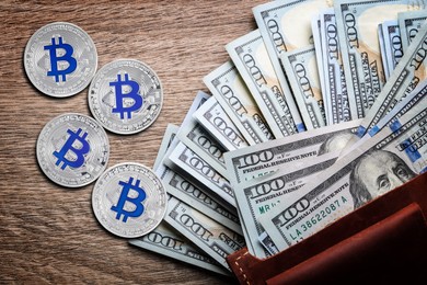 Image of Bitcoins, dollar banknotes and wallet on wooden background, flat lay