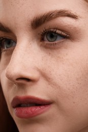 Photo of Portrait of beautiful woman with freckles, closeup