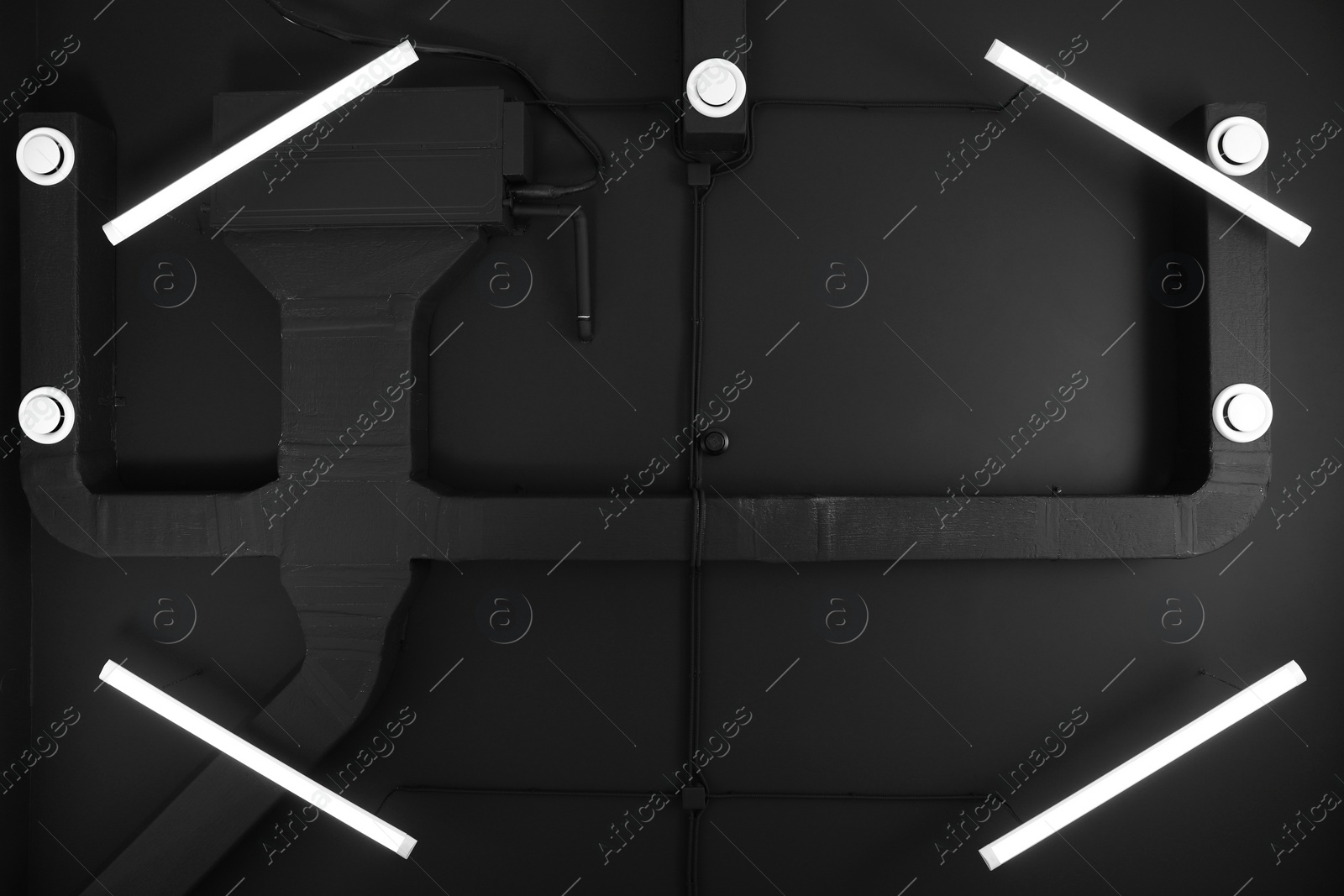 Photo of Black ceiling with modern lighting in room, bottom view