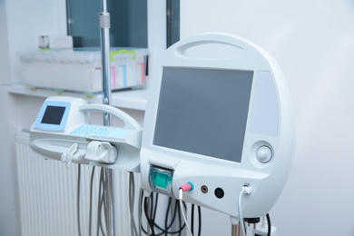 Photo of Syringe dispenser system in modern clinic. Surgery equipment