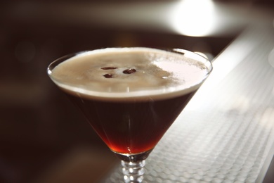 Photo of Glass of martini espresso cocktail in bar, closeup