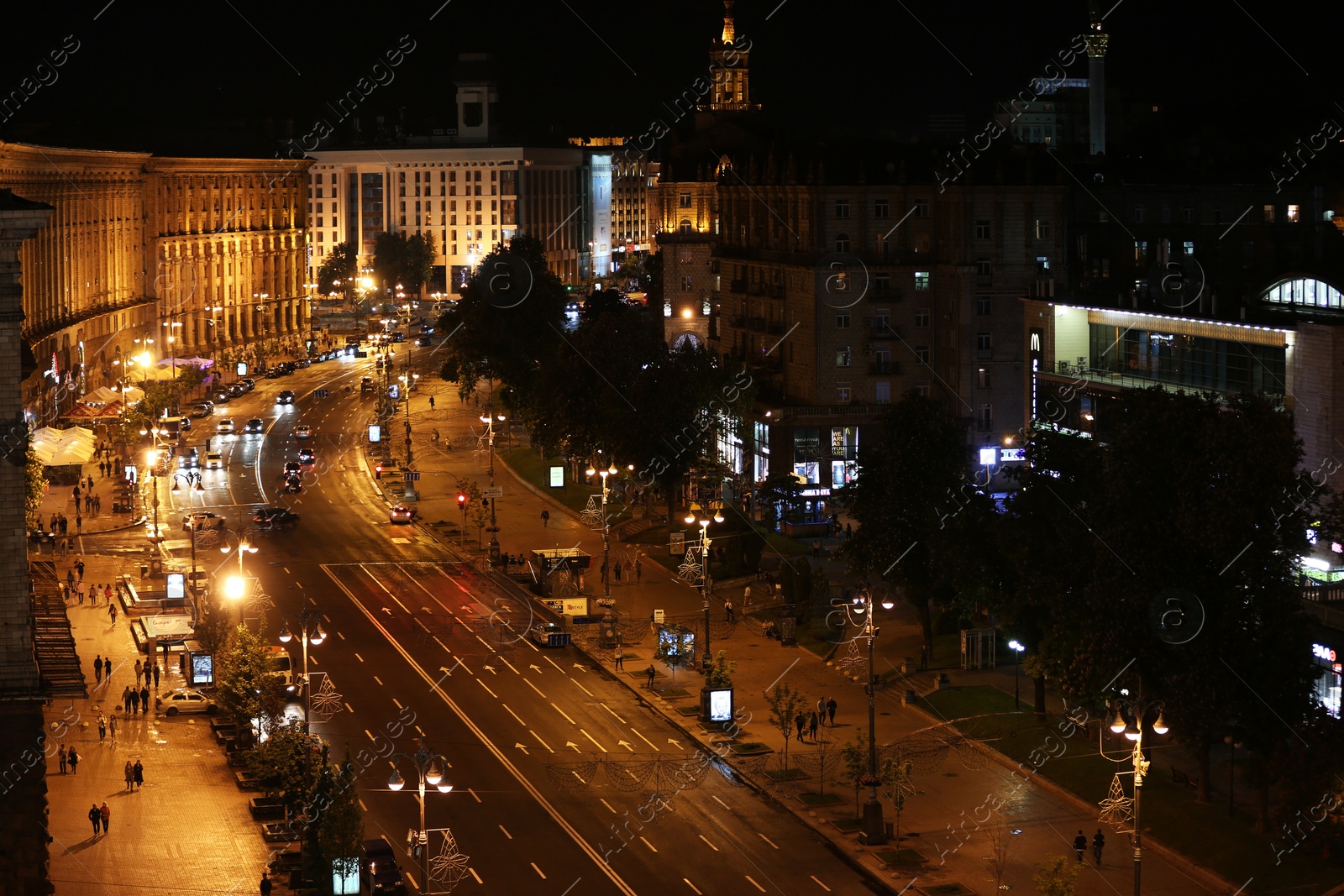 Photo of KYIV, UKRAINE - MAY 21, 2019: Night cityscape with illuminated buildings and street traffic