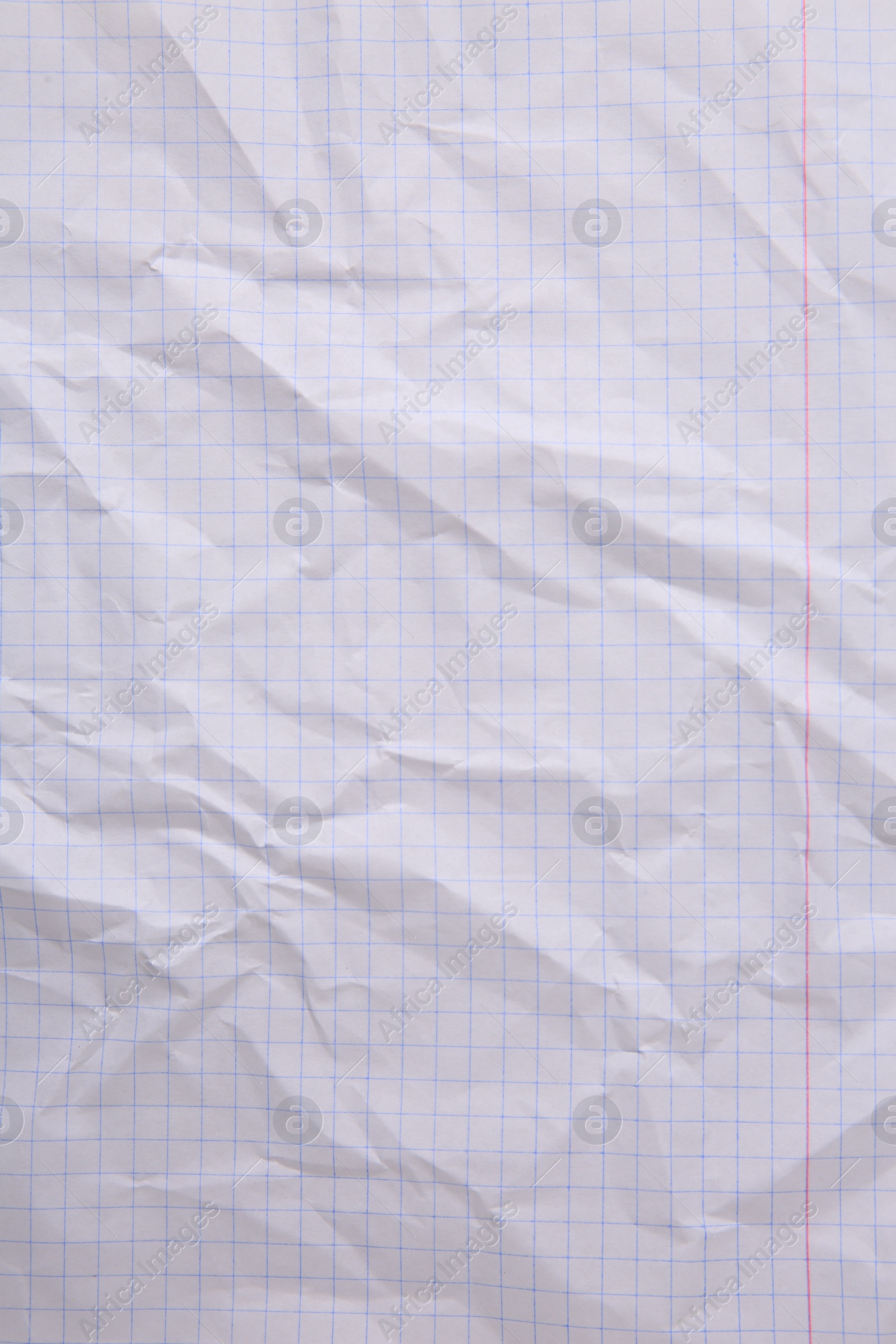 Photo of Sheet of crumpled checkered paper as background, top view