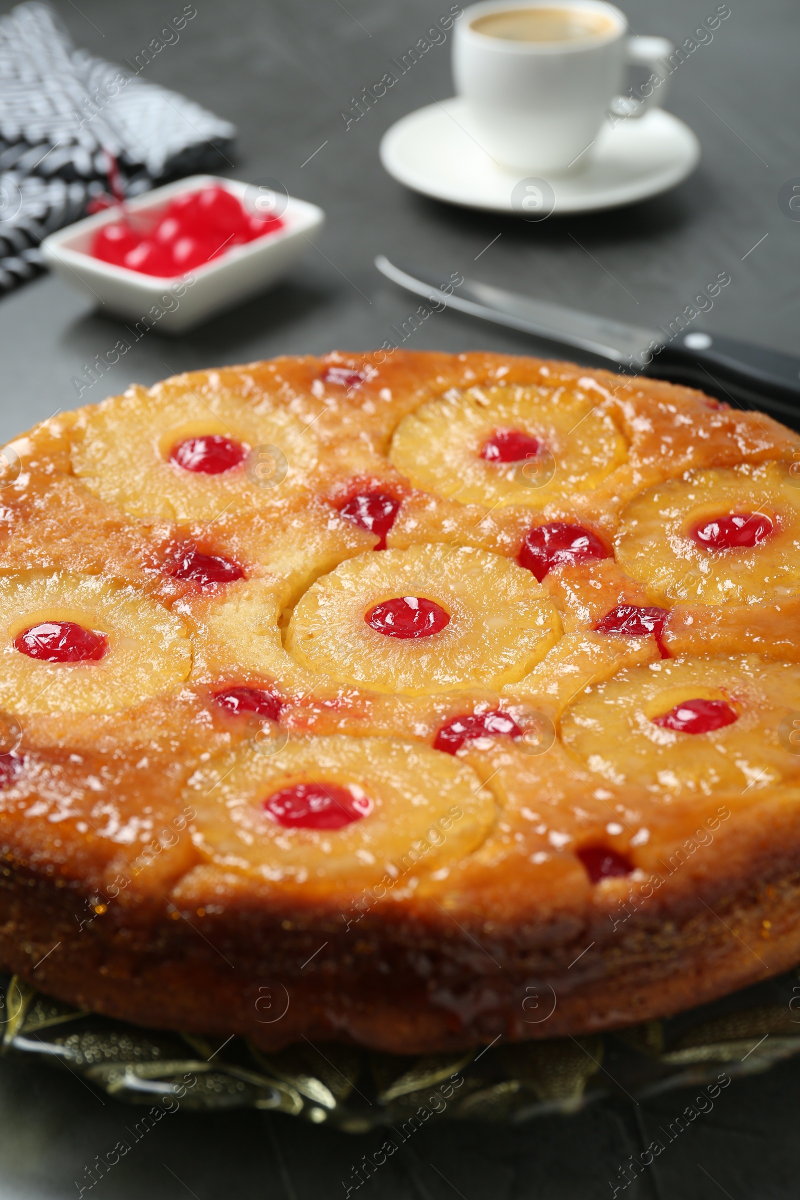 Photo of Plate with tasty pineapple cake on grey table, closeup