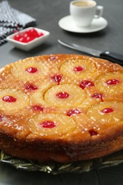 Plate with tasty pineapple cake on grey table, closeup