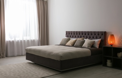 Contemporary room interior with comfortable double bed