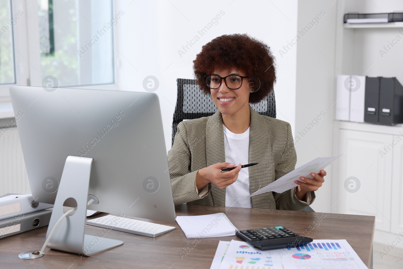 Photo of Professional accountant having video chat via computer at desk in office