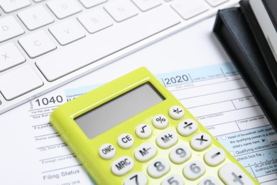 Photo of Calculator, notebooks and document on table, closeup. Tax accounting
