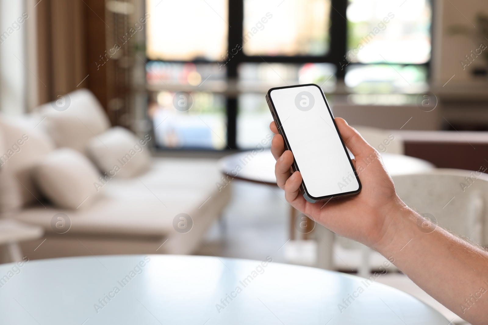 Photo of Man using mobile phone indoors, closeup. Space for text