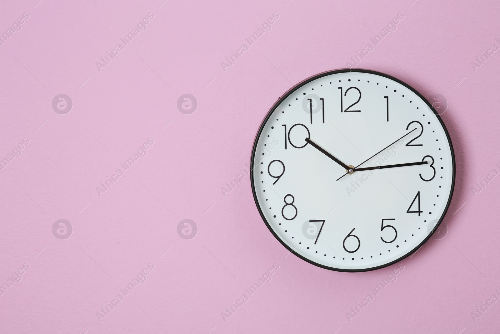 Photo of Stylish clock and space for text on color background. Time management