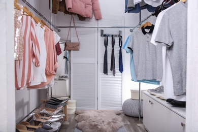 Modern dressing room with different stylish clothes and accessories