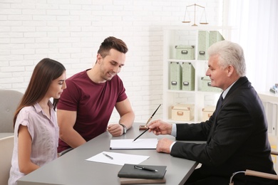 Lawyer having meeting with young couple in office