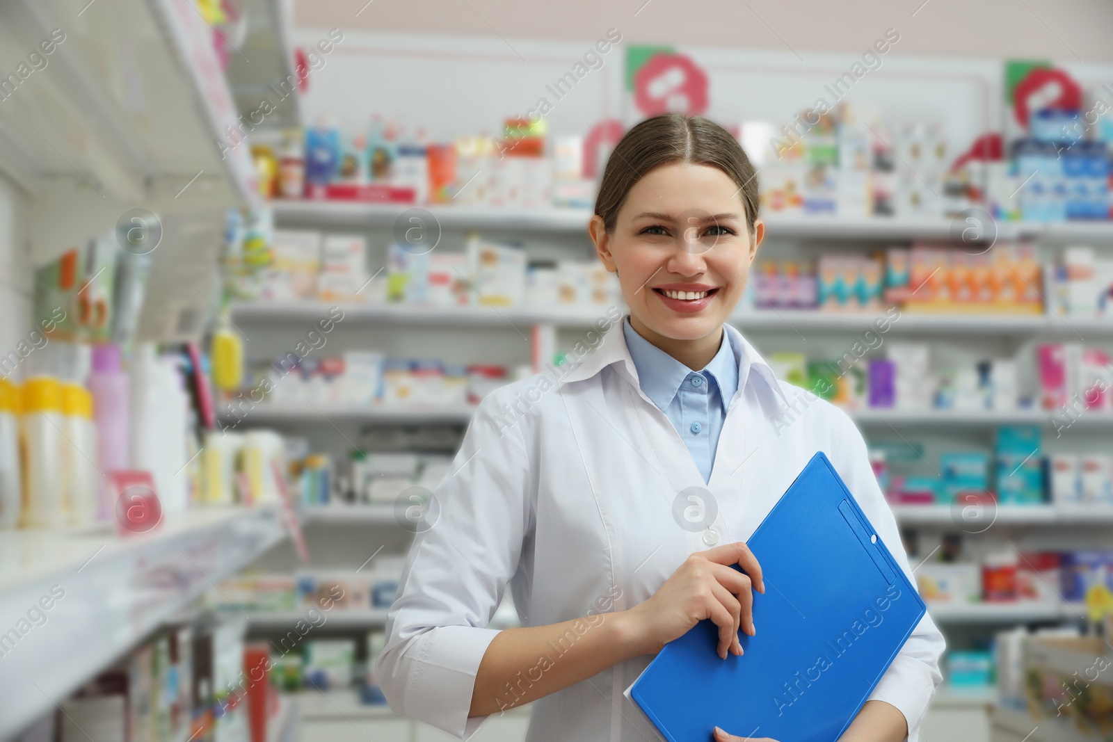 Photo of Professional pharmacist with clipboard in modern drugstore