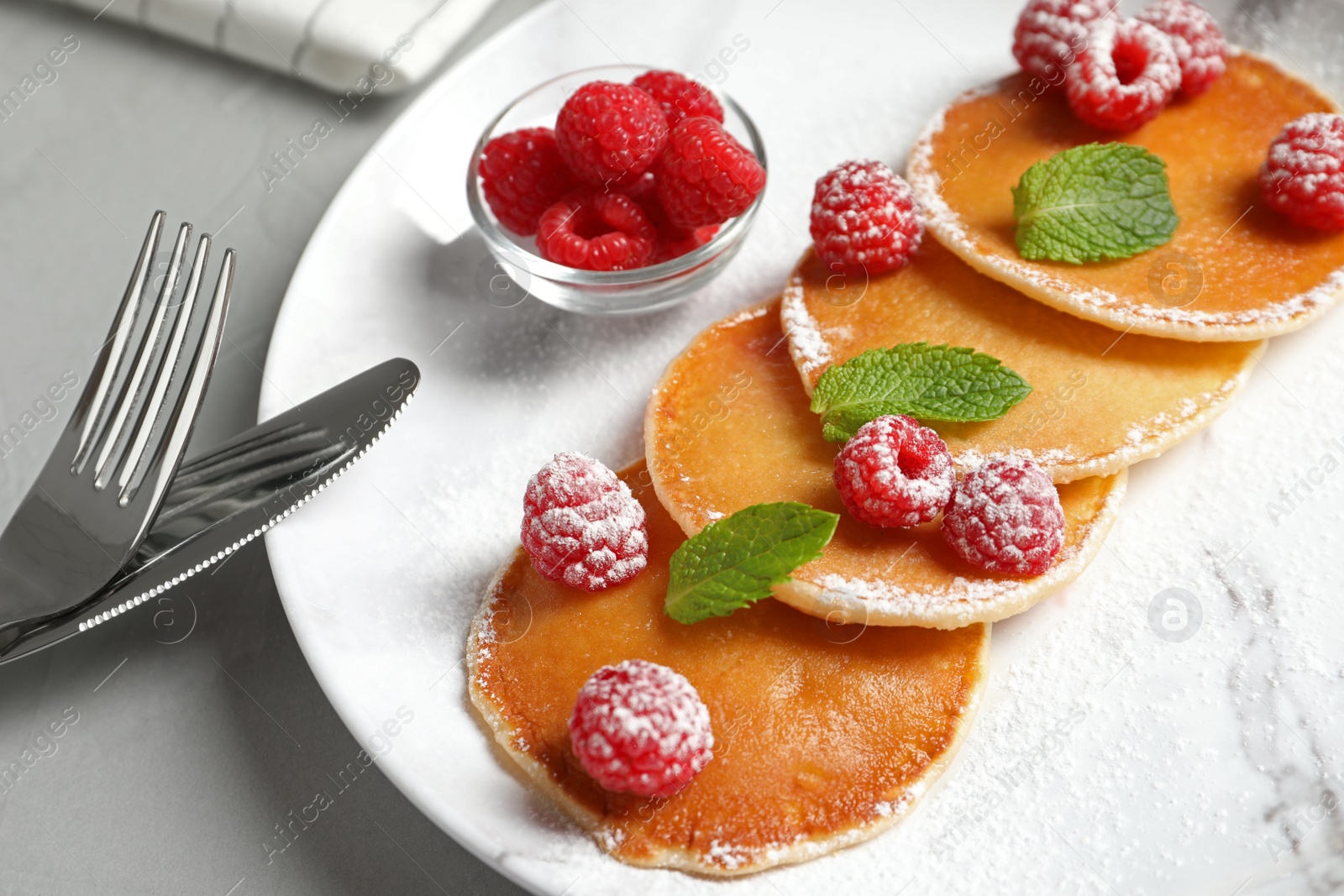 Photo of Tasty pancakes with berries and mint on plate