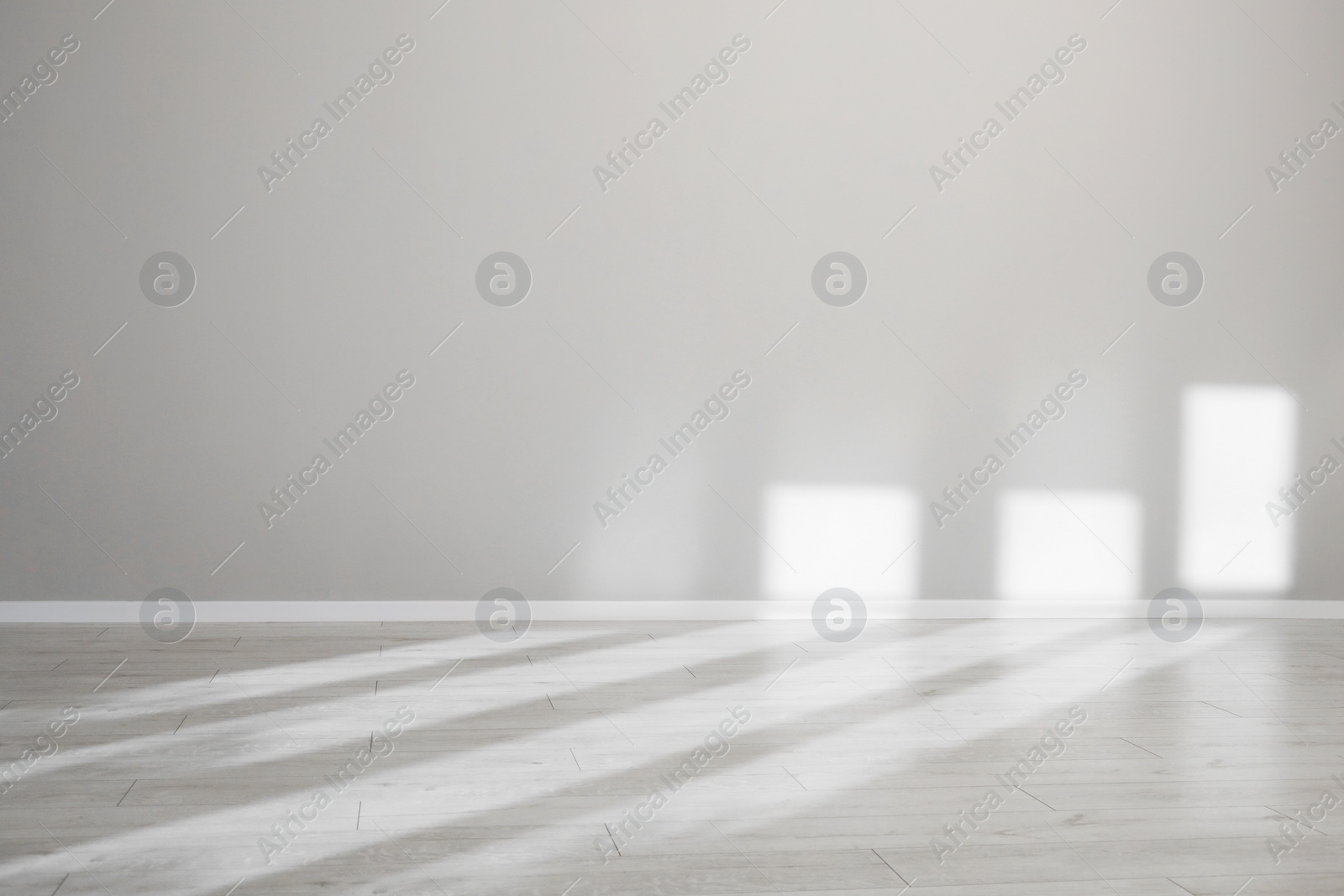Photo of Light and shadows from window on floor and wall indoors