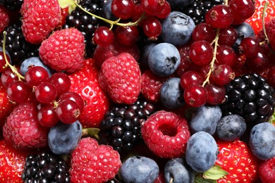 Photo of Many different fresh ripe berries as background, top view