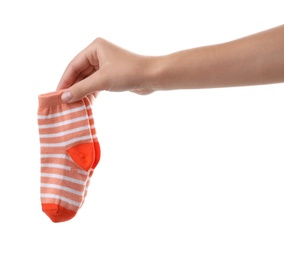 Photo of Woman holding pair of cute child socks on white background, closeup