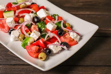 Photo of Plate with delicious salad on table, closeup