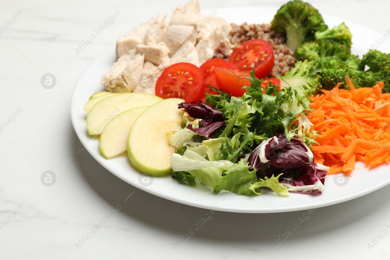 Photo of Balanced diet and healthy foods. Plate with different delicious products on white marble table, closeup